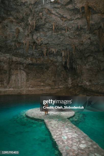 woman standing  in cenote in yucatan, mexico - cenote bildbanksfoton och bilder