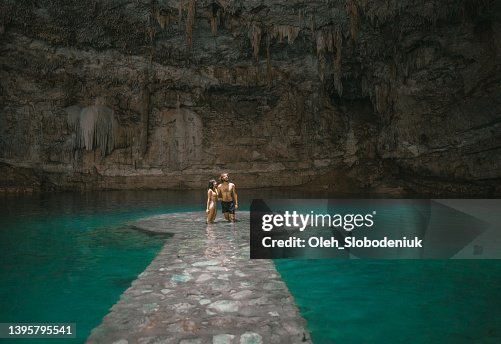 Couple standing in Cenote in Yucatan, Mexico Couple standing in Cenote in Yucatan, Mexico