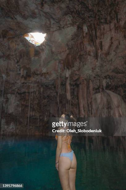 woman standing  in cenote in yucatan, mexico - cenote mexico stock pictures, royalty-free photos & images