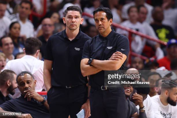 Assistant coach Chris Quinn and head coach Erik Spoelstra of the Miami Heat look on against the Philadelphia 76ers during the second half in Game Two...