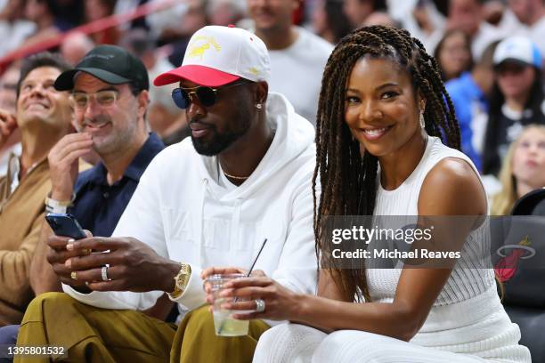 Former Miami Heat player Dwyane Wade and his wife, Gabrielle Union, look on courtside during the second half in Game Two of the Eastern Conference...