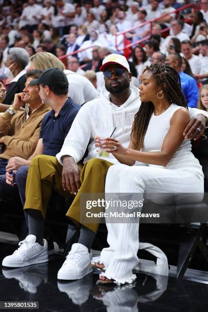 Former Miami Heat player Dwyane Wade and his wife, Gabrielle Union, look on courtside during the second half in Game Two of the Eastern Conference...