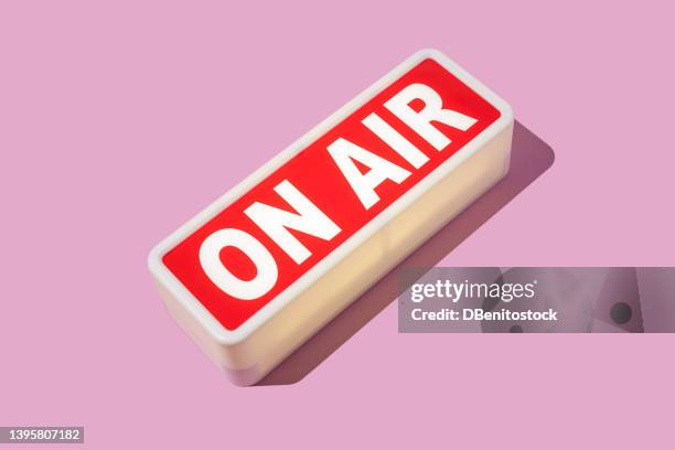 radio and sound recording warning light that reads: 'on air' with hard shadow on pink background. podcast, radio, broadcast, radio show, entertainment and journalism concept. - live broadcast stock pictures, royalty-free photos & images