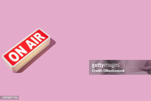radio and sound recording warning light that reads: 'on air' with hard shadow, on the left side, on pink background. podcast, radio, broadcast, radio show, entertainment and journalism concept. - on air sign imagens e fotografias de stock