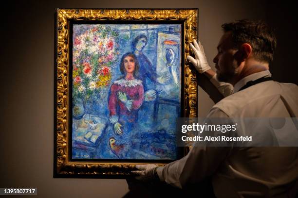 An art handler holds "Le Modele" by Marc Chagall during a press preview of The Macklowe Collection and Spring Evening Sales Preview atSotheby's on...