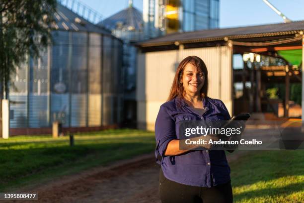 multiracial woman with grain silo background - south america farm stock pictures, royalty-free photos & images