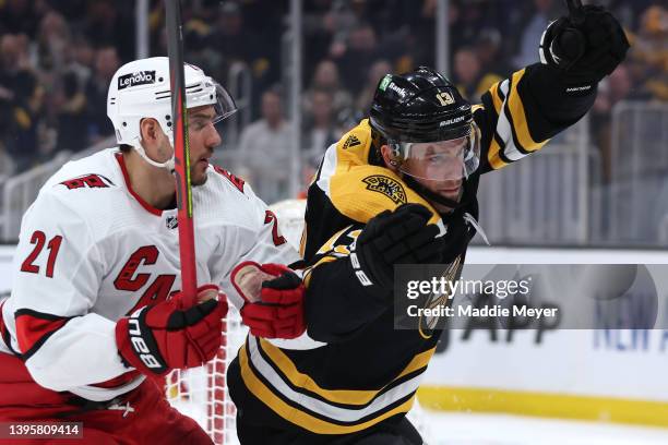 Charlie Coyle of the Boston Bruins celebrates with Nino Niederreiter of the Carolina Hurricanes after scoring a goal during the first period of Game...