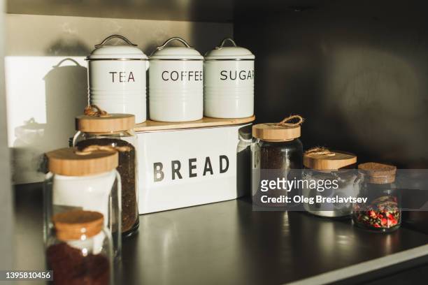 set of jars and containers in kitchen for convenient storage. no plastic, eco-friendly and sustainable lifestyle. - tea can stockfoto's en -beelden