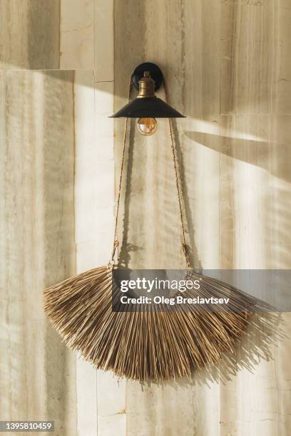 minimalistic and natural interior decor. hanging handmade wicker macrame on vintage lamp. - bohemian background stock pictures, royalty-free photos & images