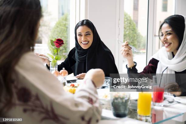 young saudi women enjoying lunch in riyadh restaurant - saudi lunch stock pictures, royalty-free photos & images