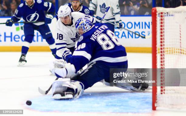 Andrei Vasilevskiy of the Tampa Bay Lightning stops a shot from Mitchell Marner of the Toronto Maple Leafs in the first first period during Game...