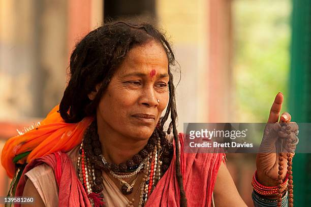 By the banks of the auspicious and great Ganges in Haridwar, India this female Shiva swami gives blessings to passers by and devotees. It is quite...