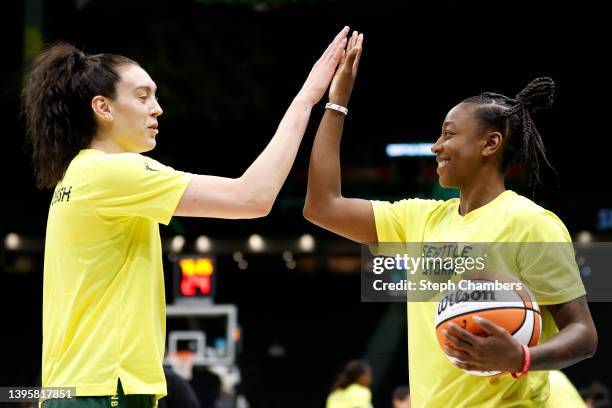 Breanna Stewart and Jewell Loyd of the Seattle Storm high five before the game against the Minnesota Lynx at Climate Pledge Arena on May 06, 2022 in...