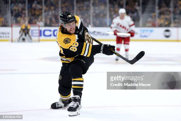 David Pastrnak of the Boston Bruins takes a shot against the Carolina Hurricanes during the third period of Game Three of the First Round of the 2022...