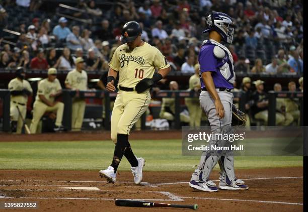 Josh Rojas of the Arizona Diamondbacks scores on a sacrifice fly hit by Seth Beer against the Colorado Rockies during the second inning at Chase...