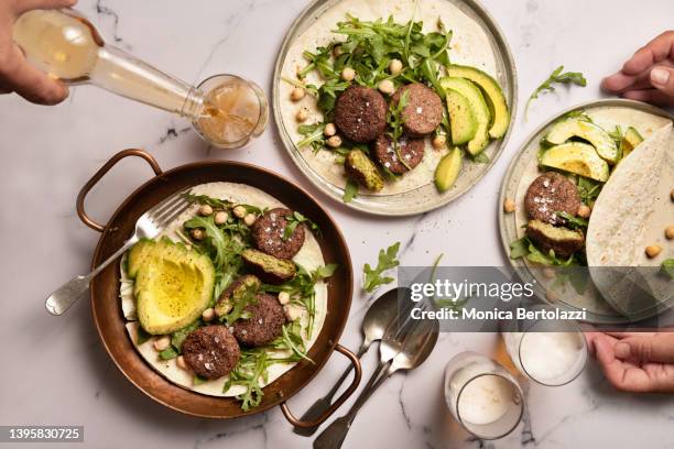 falafel and pita bread on marble table - veganist stockfoto's en -beelden