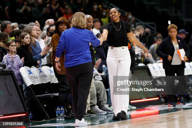 Head coach Cheryl Reeve of the Minnesota Lynx and head coach Noelle Quinn of the Seattle Storm shake hands after the game at Climate Pledge Arena on...