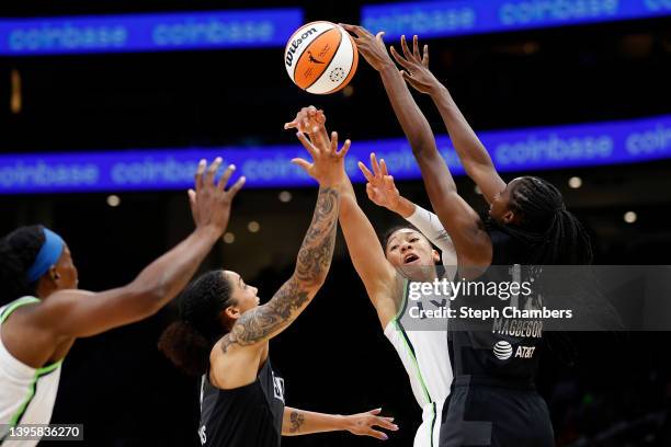 Aerial Powers of the Minnesota Lynx has her pass blocked by Ezi Magbegor of the Seattle Storm during the first half at Climate Pledge Arena on May...