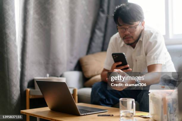 asian young adults hand holding medicine bottle and use phone  video calls telemedicine  with doctors for consultation healthy and  medical at home - mentoring virtual stock pictures, royalty-free photos & images