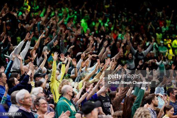 Seattle Storm fans cheer during a timeout between the Seattle Storm and the Minnesota Lynx at Climate Pledge Arena on May 06, 2022 in Seattle,...