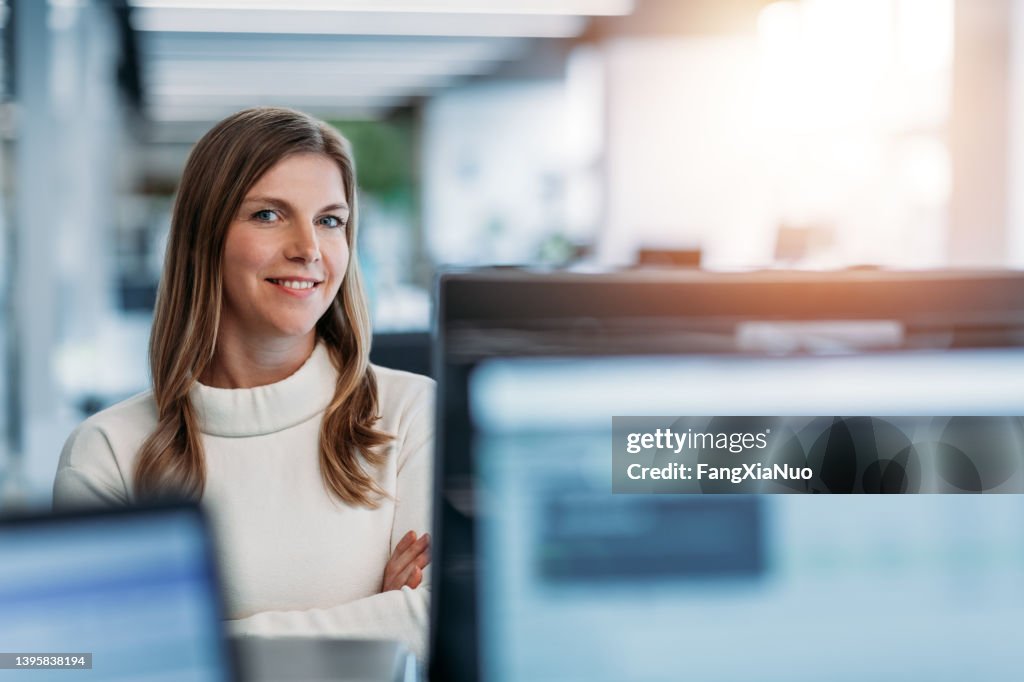 Portrait of woman smiling in modern business office
