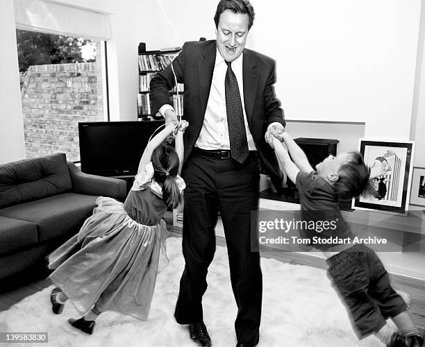 David Cameron playing with his children Arthur and Nancy at their London home.