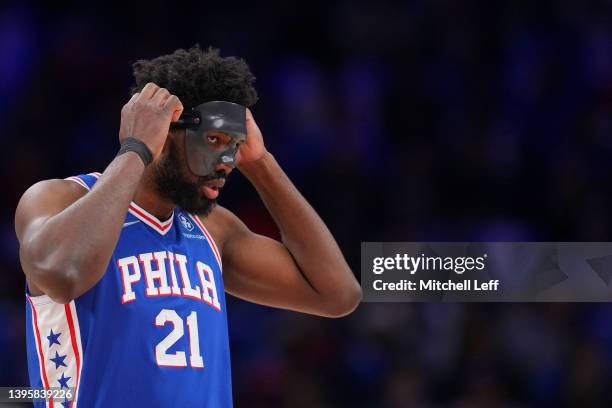 Joel Embiid of the Philadelphia 76ers puts on his protective face guard during Game Three of the 2022 NBA Playoffs Eastern Conference Semifinals...