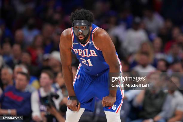 Joel Embiid of the Philadelphia 76ers looks on with his protective face guard against the Miami Heat during Game Three of the 2022 NBA Playoffs...