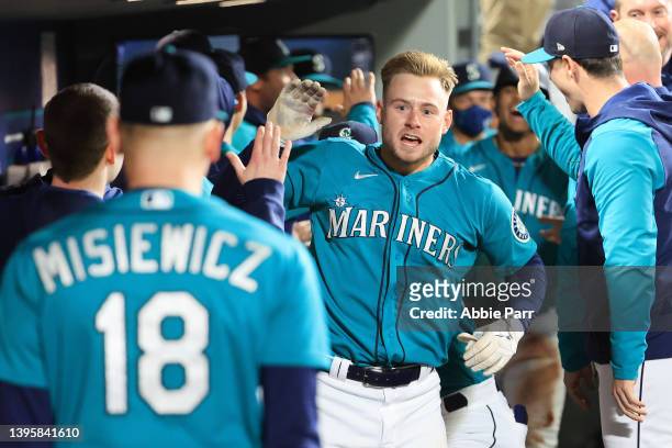 Jarred Kelenic of the Seattle Mariners celebrates in the dugout after hitting a two-run home run against the Tampa Bay Rays to take a 6-5 lead during...