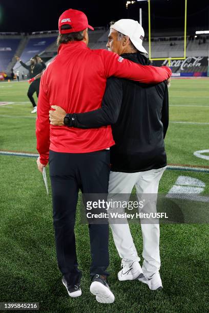 Head coach Jeff Fisher of Michigan Panthers and head coach Bart Andrus of Philadelphia Stars talk on the field after the Philadelphia Stars defeated...
