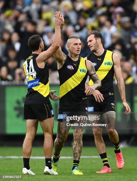 Dustin Martin of the Tigers is congratulated by team mates after kicking a goal during the round eight AFL match between the Richmond Tigers and the...