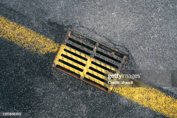 high angle view of gutter on road - égout photos et images de collection