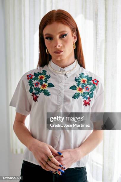 portrait of a caucasian transgender woman with red hair indoors - transvrouw stockfoto's en -beelden