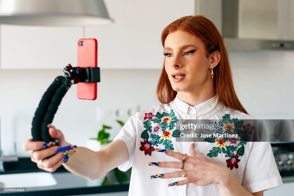 Transgender woman influencer recording herself with her smartphone