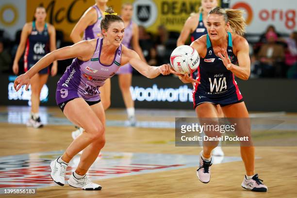 Gabi Simpson of the Firebirds and Liz Watson of the Vixens contest the ball during the round eight Super Netball match between Melbourne Vixens and...