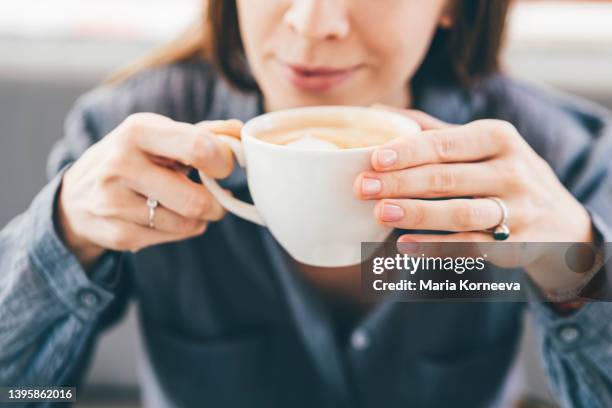 woman enjoying morning with a cup of coffee. - mug face stock pictures, royalty-free photos & images