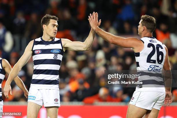 Jeremy Cameron of the Geelong Cats celebrates with Tom Hawkins of the Geelong Cats after kicking a goal during the round eight AFL match between the...