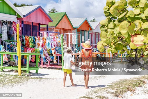 Cute little boy with mother looking at souvenirs on a beach Cute little boy with mother looking at souvenirs on a beach