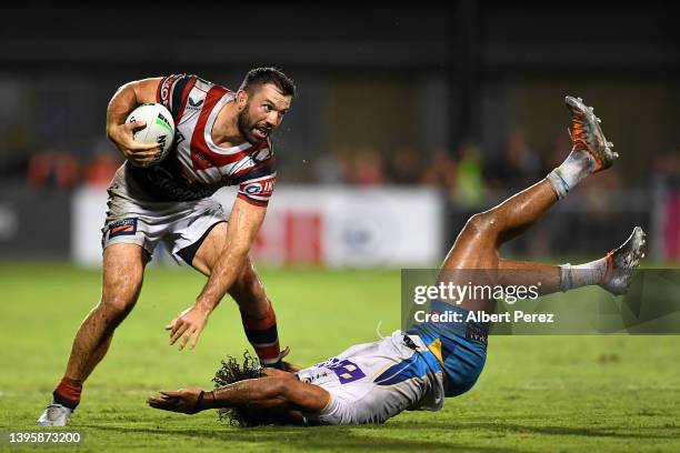 James Tedesco of the Roosters evades the tackle from Brian Kelly of the Titans during the round nine NRL match between the Sydney Roosters and the...
