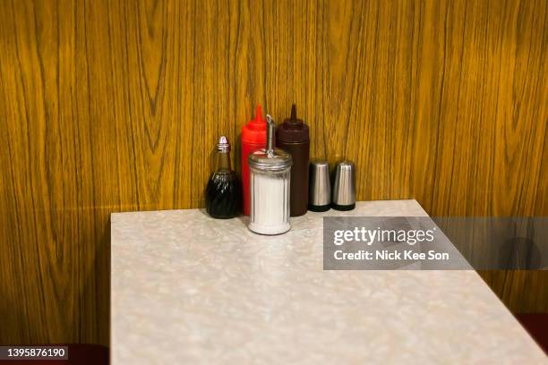 condiments on a cafe table - vintage restaurant stock pictures, royalty-free photos & images