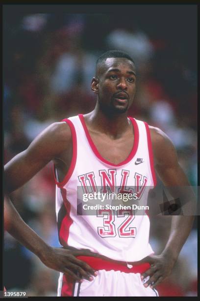 Guard Stacey Augmon of the UNLV Running Rebels looks on during a game in the 1989-90 season at the Thomas & Mack Center in Las Vegas, Nevada.