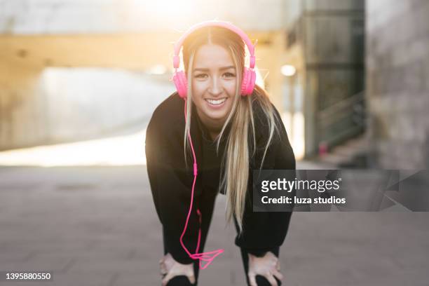 portrait of a smiling woman in the city - bending over stock pictures, royalty-free photos & images