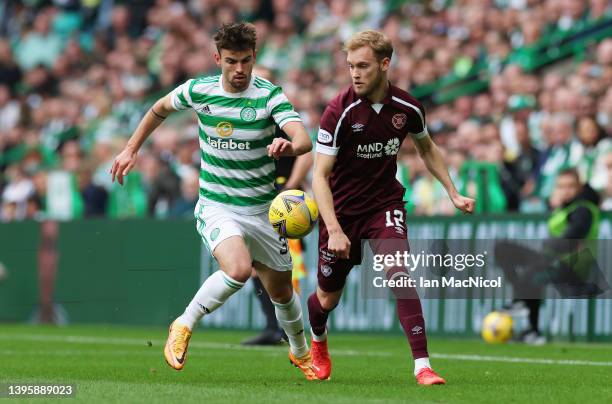 Matt O'Riley of Celtic battles for possession with Nathaniel Atkinson of Heart of Midlothian during the Cinch Scottish Premiership match between...