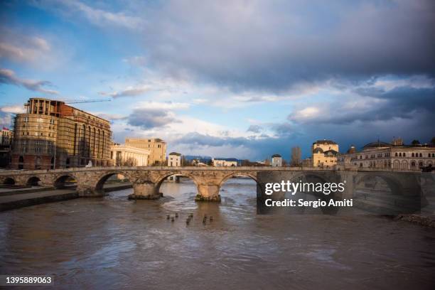 skopje stone bridge at sunrise - skopje stock-fotos und bilder