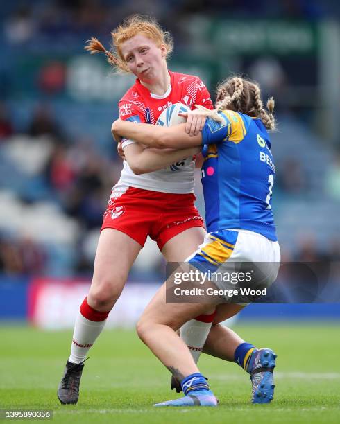 Rebecca Rotheram of St Helens is tackled by Caitlin Beevers of Leeds Rhinos during the Betfred Women's Super League Grand Final match between Leeds...