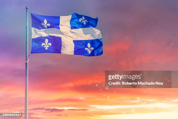 the flag of the quebec province - québec stock pictures, royalty-free photos & images