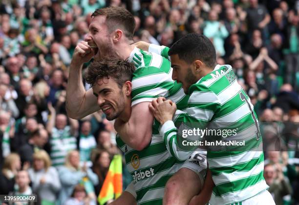 Matt O'Riley of Celtic is congratulated by teammates Anthony Ralston and Liel Abada after scoring their team's third goal during the Cinch Scottish...