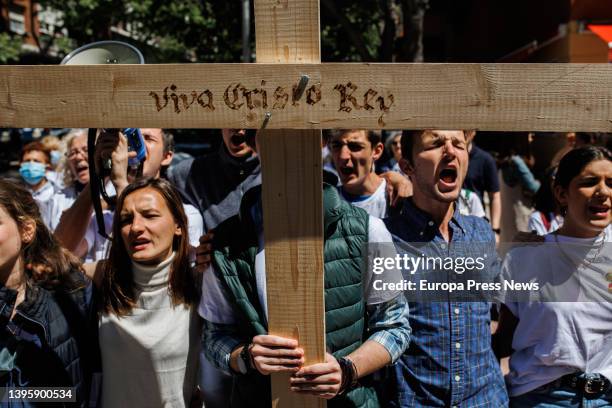 Demonstrators with a cross that reads 'Viva Cristo Rey' during an anti-abortion march from Plaza de Cuzco to the Dator clinic, on May 7 in Madrid,...