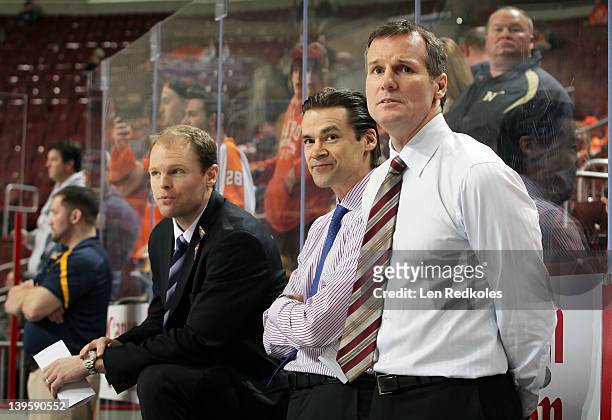 Assistant Coaches James Patrick, Teppo Numminen and Kevyn Adams of the Buffalo Sabres watch warm-ups prior to their game against the Philadelphia...