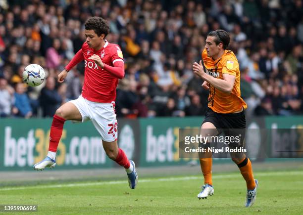 Brennan Johnson of Nottingham Forest runs with the ball under pressure from Jacob Greaves of Hull City during the Sky Bet Championship match between...